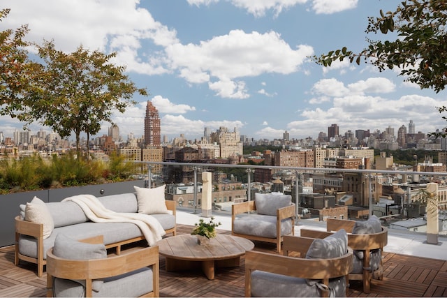 view of patio with a view of skyline, an outdoor living space, and a balcony