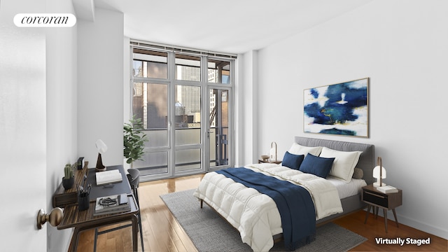 1600 Broadway Unit 17A, New York City, NY 10019 - bedroom featuring access to outside and wood finished floors