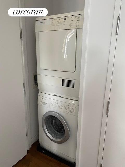 1600 Broadway Unit 17A, New York City, NY 10019 - washroom with stacked washer / drying machine and dark wood-style floors