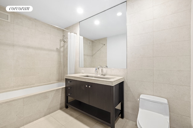 1600 Broadway Unit 17A, New York City, NY 10019 - full bath featuring toilet, tile patterned flooring, tile walls, vanity, and tiled shower / bath combo