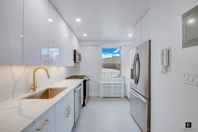 kitchen featuring white cabinetry, a sink, stainless steel appliances, electric panel, and modern cabinets