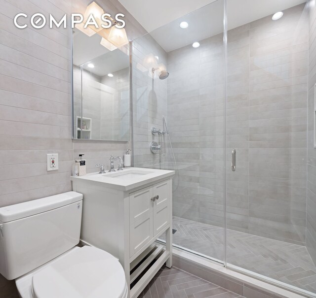 217 W 22nd St, New York City, NY 10011 - bathroom featuring toilet, vanity, a shower stall, and recessed lighting