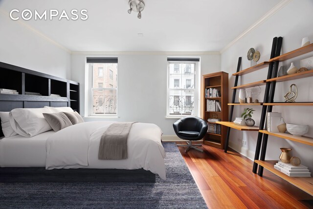 217 W 22nd St, New York City, NY 10011 - bedroom with wood finished floors, crown molding, and baseboards
