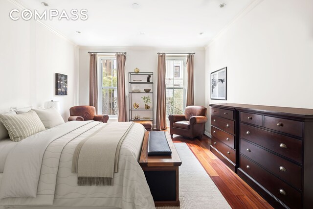 217 W 22nd St, New York City, NY 10011 - bedroom featuring ornamental molding, multiple windows, and light wood-style floors