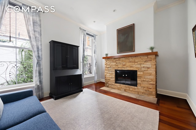 living area with baseboards, crown molding, and wood finished floors