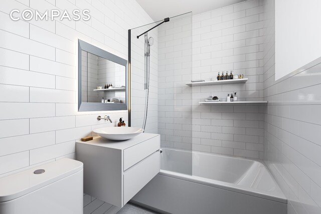 433 W 54th St Unit 1, New York City, NY 10019 - full bathroom featuring bathing tub / shower combination, vanity, tile walls, and toilet