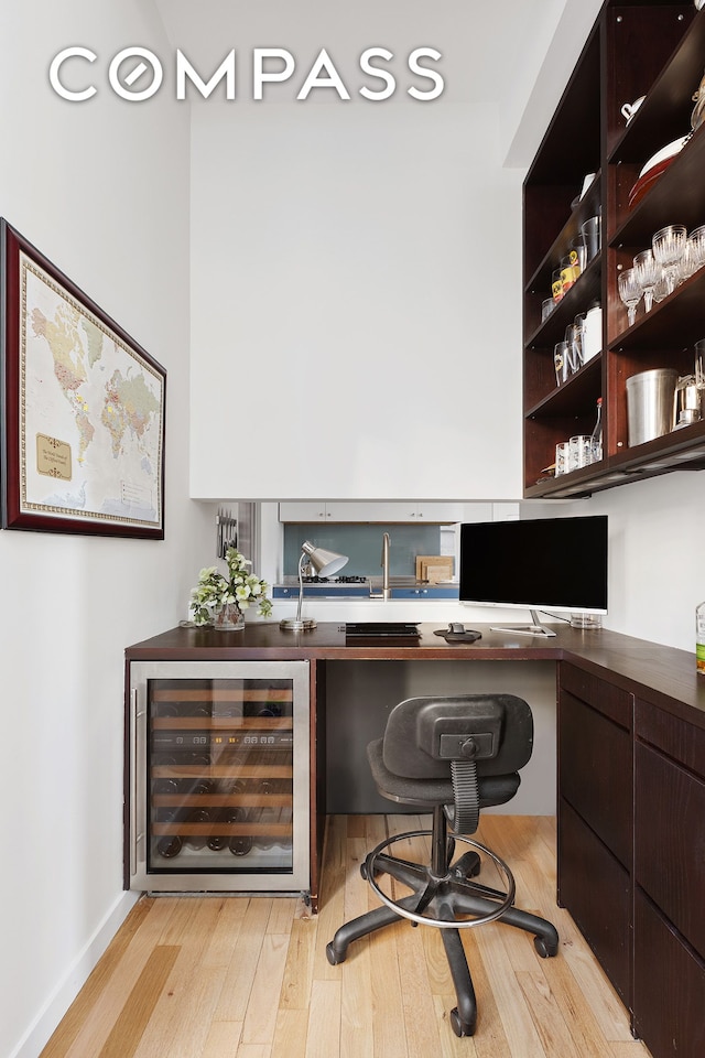 100 Hudson St Unit 4D, New York City, NY 10013 - home office featuring wine cooler, light wood-style flooring, and built in desk