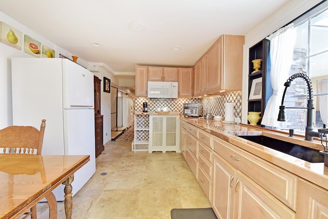 34 Fort Charles Place, New York City, NY 10463 - kitchen featuring white appliances, light brown cabinets, a sink, tasteful backsplash, and light countertops