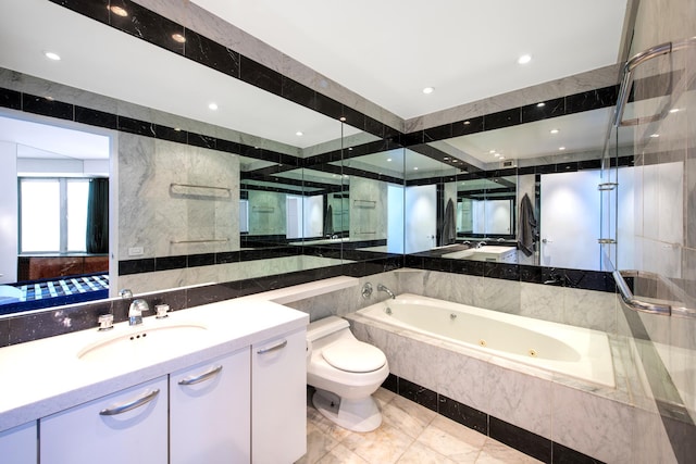 bathroom featuring a jetted tub, tile walls, a shower with shower door, vanity, and toilet