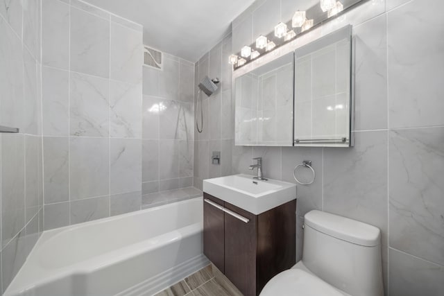 79-10 34th Ave Unit 3S, New York City, NY 11372 - full bath featuring vanity, toilet, tile walls, and bathing tub / shower combination