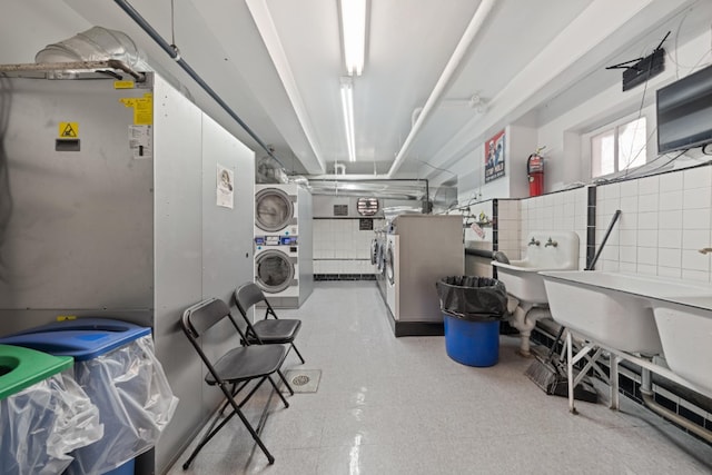 79-10 34th Ave Unit 3S, New York City, NY 11372 - basement with stacked washer and clothes dryer and tile patterned floors