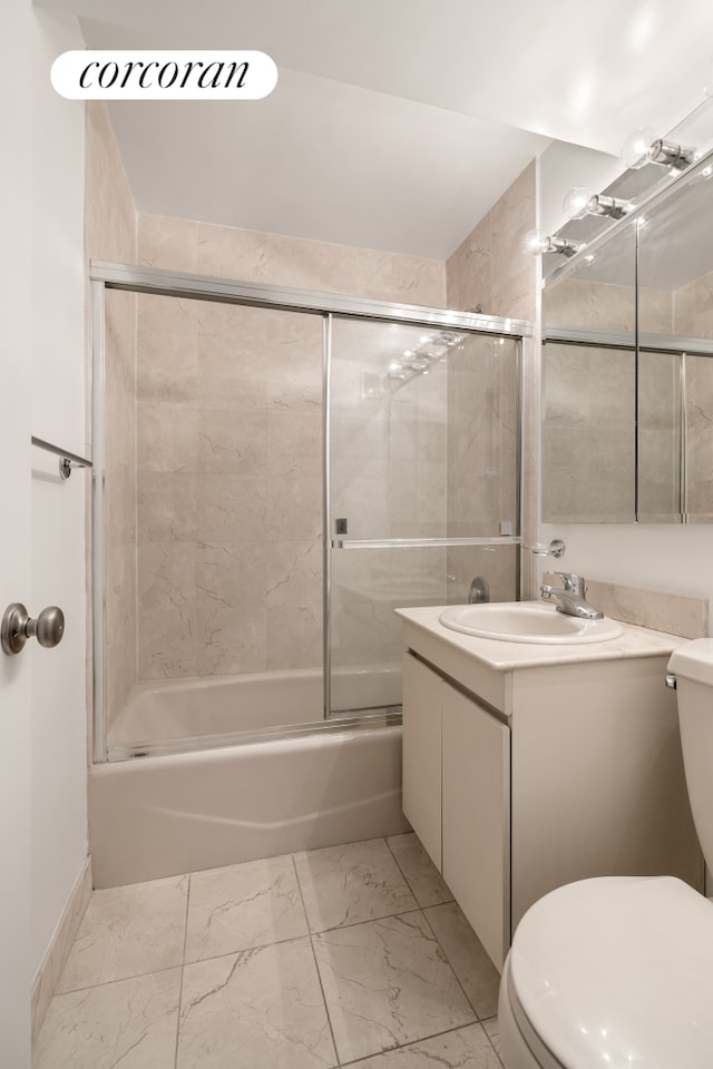 333 E 66th St Unit 12E, New York City, NY 10065 - full bath featuring toilet, marble finish flooring, vanity, and bath / shower combo with glass door