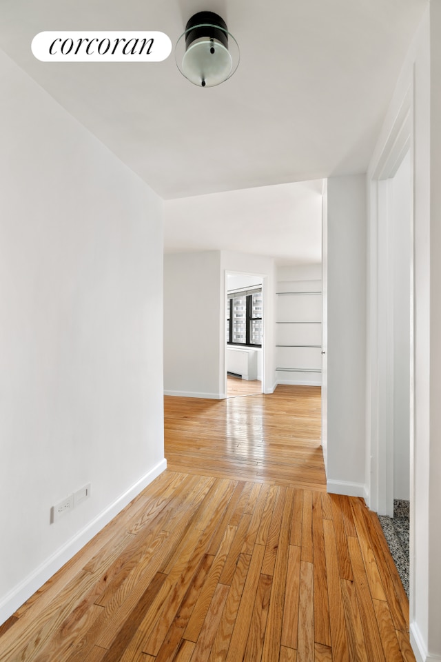 333 E 66th St Unit 12E, New York City, NY 10065 - unfurnished living room featuring light wood-type flooring and baseboards