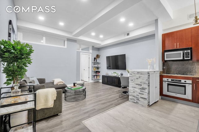 living room featuring recessed lighting and light wood-style flooring