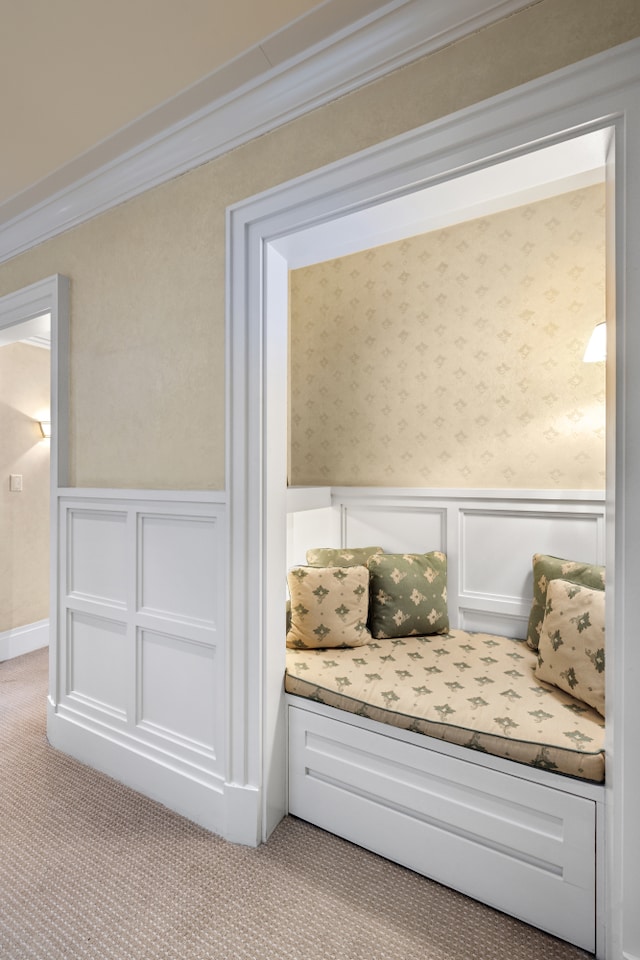 333 E 68th Street Penthouse, New York City, NY 10065 - sitting room featuring carpet floors, a wainscoted wall, crown molding, a decorative wall, and wallpapered walls