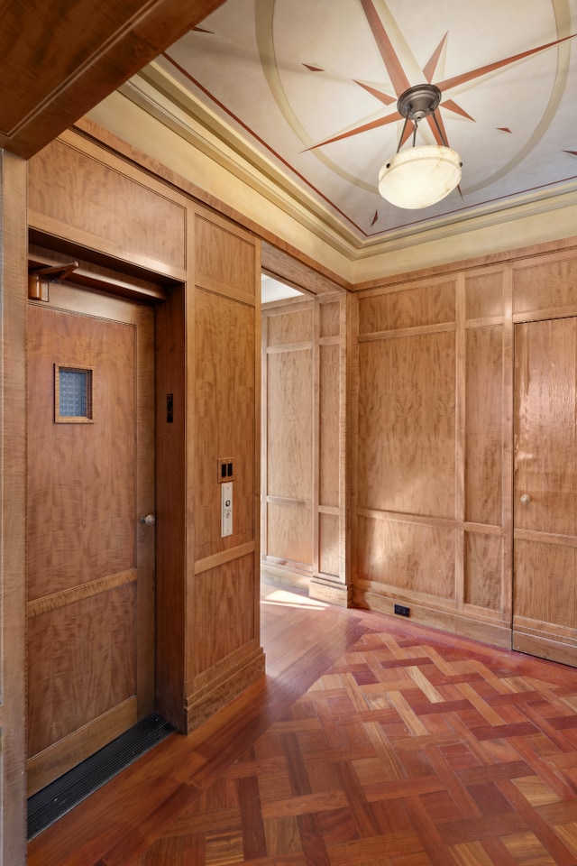 333 E 68th Street Penthouse, New York City, NY 10065 - empty room featuring elevator, wooden walls, and a ceiling fan