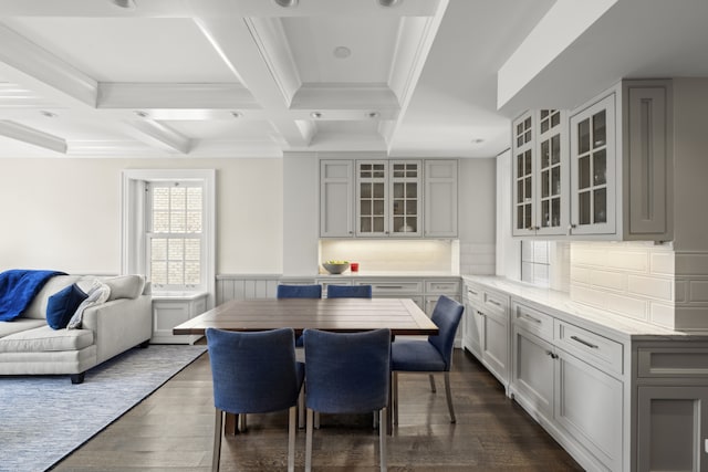 333 E 68th Street Penthouse, New York City, NY 10065 - dining area with dark wood-style floors, crown molding, coffered ceiling, beam ceiling, and a wainscoted wall