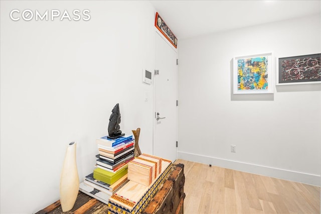 office area featuring baseboards and wood finished floors