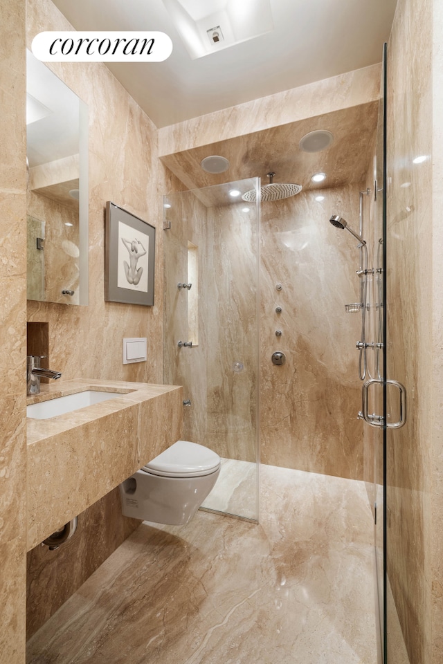 bathroom with a sink, tile walls, toilet, and a shower stall