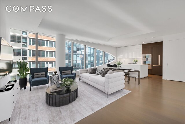 520 W 28th St Unit 18, New York City, NY 10001 - living room with wood finished floors and a wall of windows