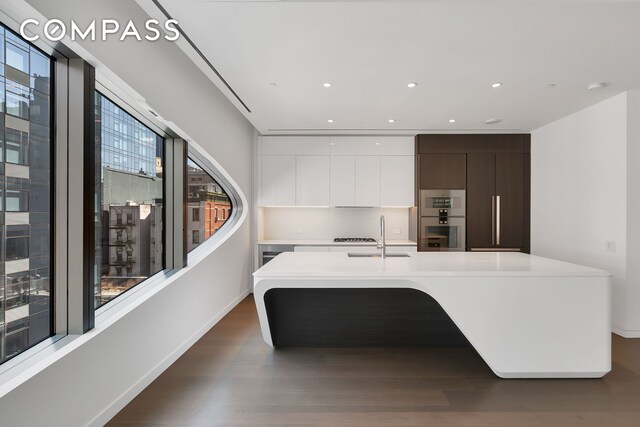 520 W 28th St Unit 18, New York City, NY 10001 - kitchen featuring white cabinetry, modern cabinets, a sink, and light countertops
