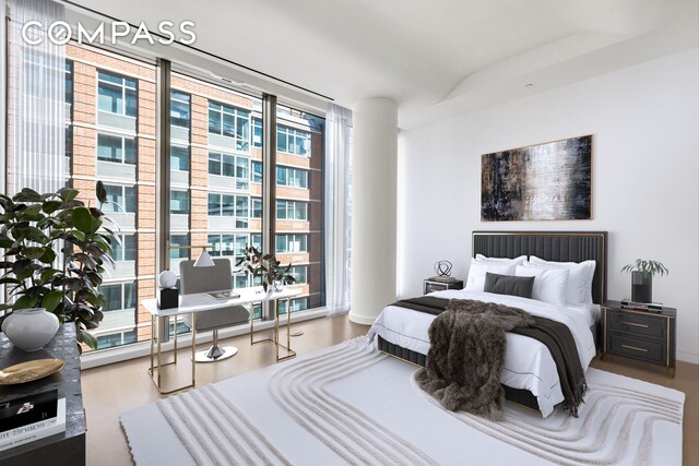 520 W 28th St Unit 18, New York City, NY 10001 - bedroom with wood finished floors and a wall of windows
