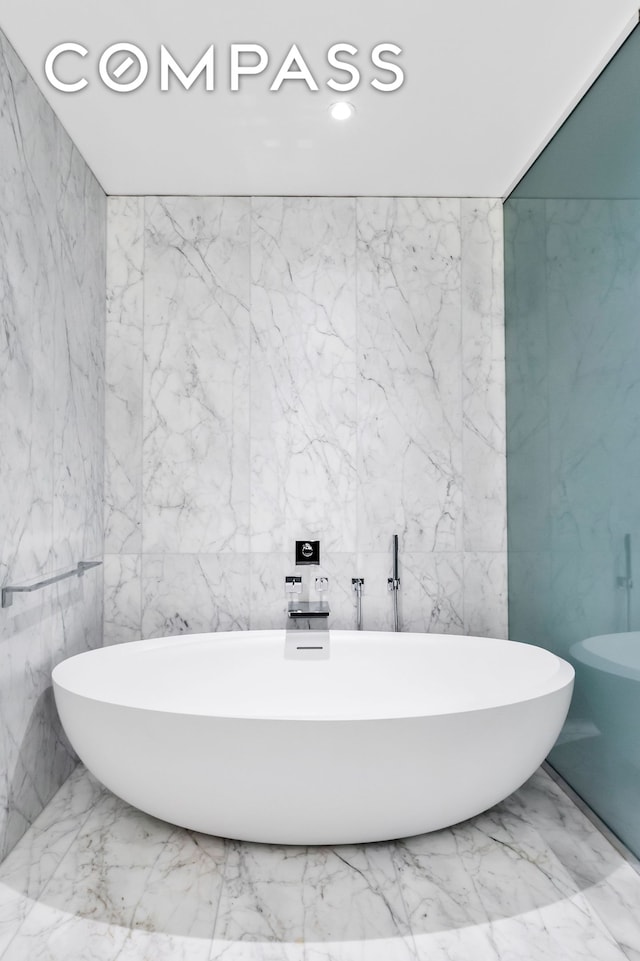 520 W 28th St Unit 18, New York City, NY 10001 - bathroom with a freestanding tub, marble finish flooring, and recessed lighting