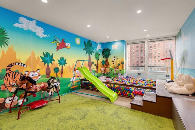 rec room with recessed lighting, carpet flooring, and floor to ceiling windows