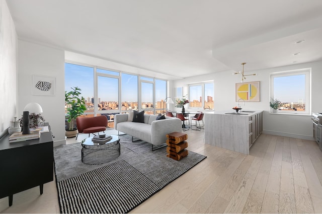 living area featuring light wood-style flooring and baseboards