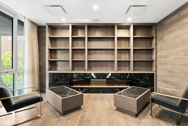 unfurnished room featuring wood finished floors, wooden walls, visible vents, and recessed lighting