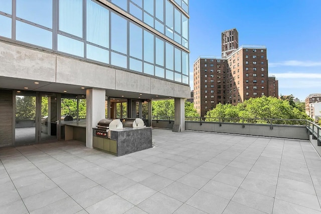 view of patio featuring grilling area, exterior kitchen, and a view of city