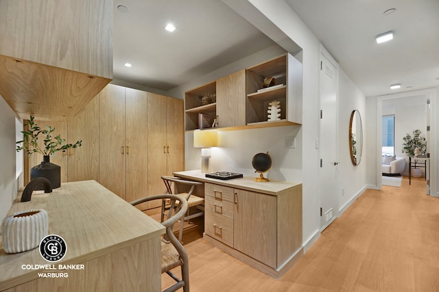 212 E 95th St Unit 2Ab, New York City, NY 10128 - office with light wood-type flooring, built in study area, and baseboards