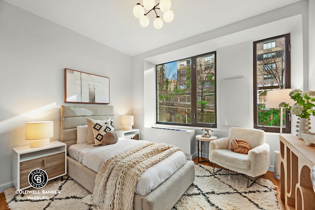 212 E 95th St Unit 2Ab, New York City, NY 10128 - bedroom featuring wood finished floors, multiple windows, a chandelier, baseboards, and lofted ceiling