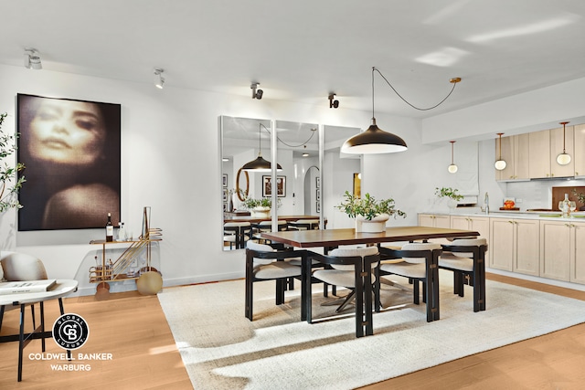 212 E 95th St Unit 2Ab, New York City, NY 10128 - dining space featuring light wood-style flooring, arched walkways, and baseboards