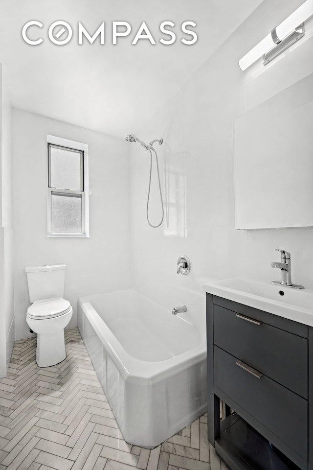 bathroom with toilet, tub / shower combination, and vanity