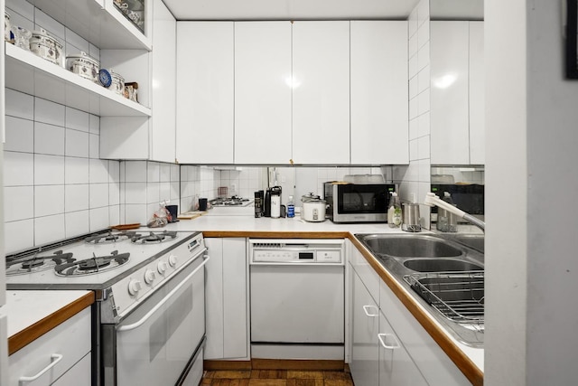 230 E 15th St Unit 3N, New York City, NY 10003 - kitchen featuring white appliances, backsplash, white cabinetry, and light countertops