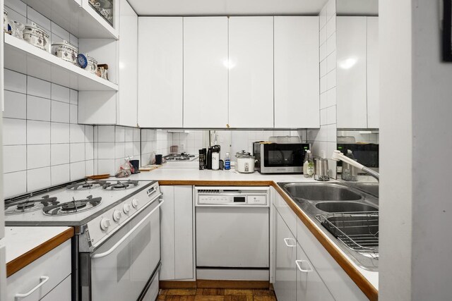 230 E 15th St Unit 3N, New York City, NY 10003 - kitchen featuring white appliances, tasteful backsplash, white cabinetry, and light countertops