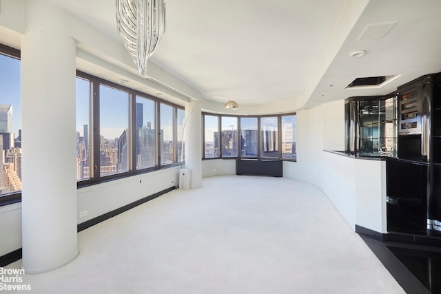 330 E 38th St Unit 51Ef, New York City, NY 10016 - unfurnished living room featuring a view of skyline and carpet