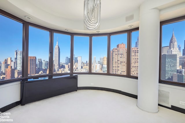 330 E 38th St Unit 51Ef, New York City, NY 10016 - unfurnished sunroom with a view of skyline, healthy amount of natural light, and baseboards