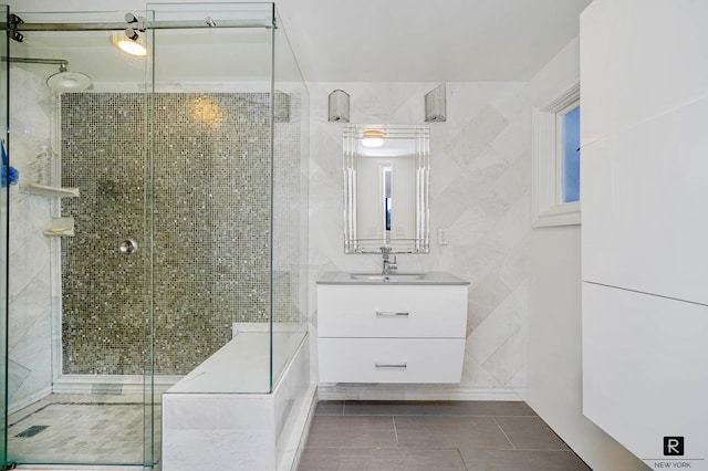 10 Bay St Unit 1-A, New York City, NY 10301 - bathroom featuring vanity, a shower stall, tile patterned flooring, and tile walls