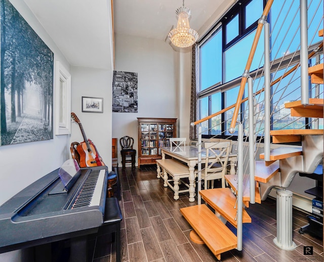 10 Bay St Unit 1-A, New York City, NY 10301 - dining space with stairway, wood finish floors, a towering ceiling, and a chandelier