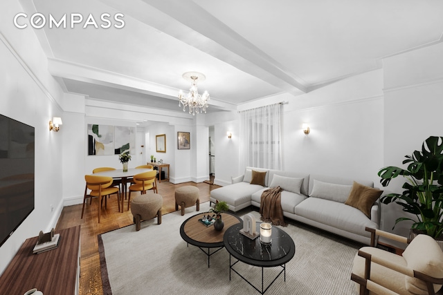 living area featuring wood finished floors, a chandelier, beamed ceiling, and baseboards