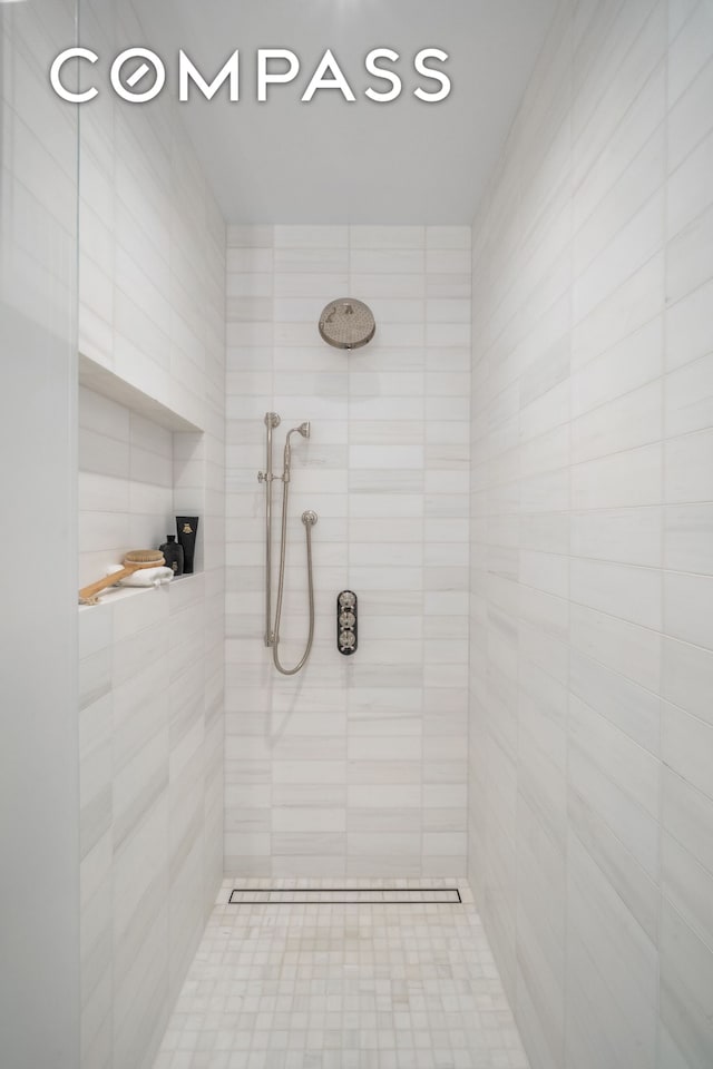 full bath featuring a tile shower