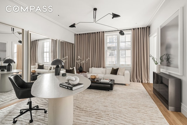 office space featuring crown molding and light wood finished floors