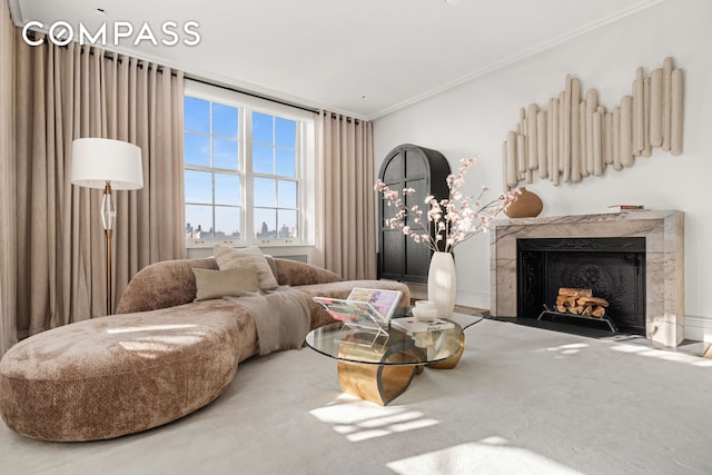 carpeted living area featuring a fireplace and crown molding