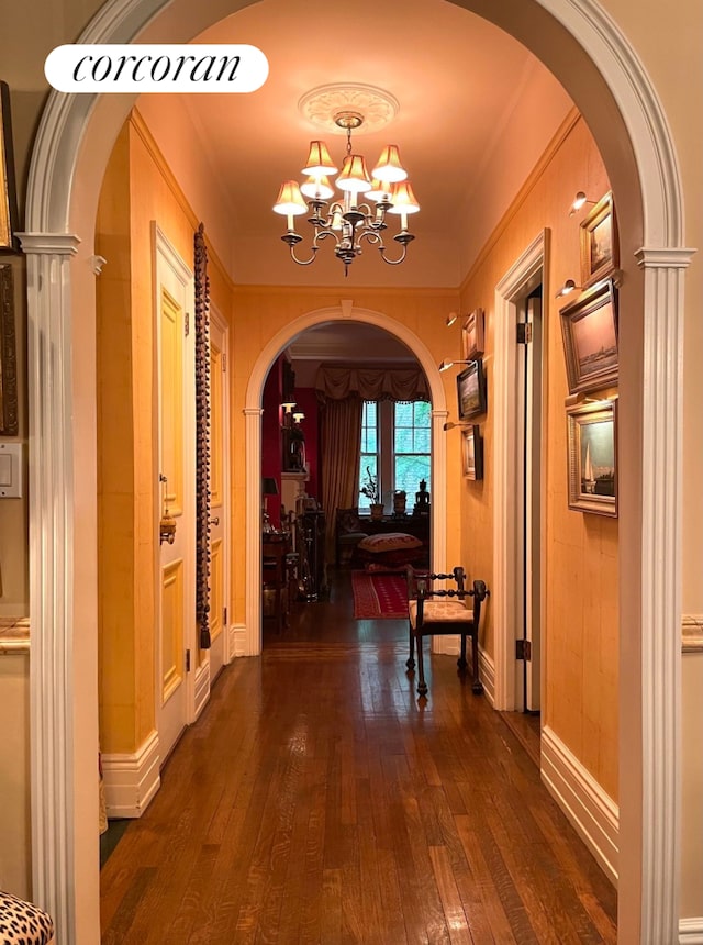 444 E 57th St Unit 5C, New York City, NY 10022 - hallway featuring arched walkways, dark wood-style floors, a chandelier, and crown molding