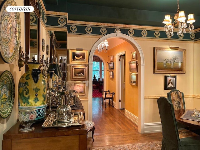 444 E 57th St Unit 5C, New York City, NY 10022 - hallway with a chandelier, arched walkways, wood finished floors, and baseboards