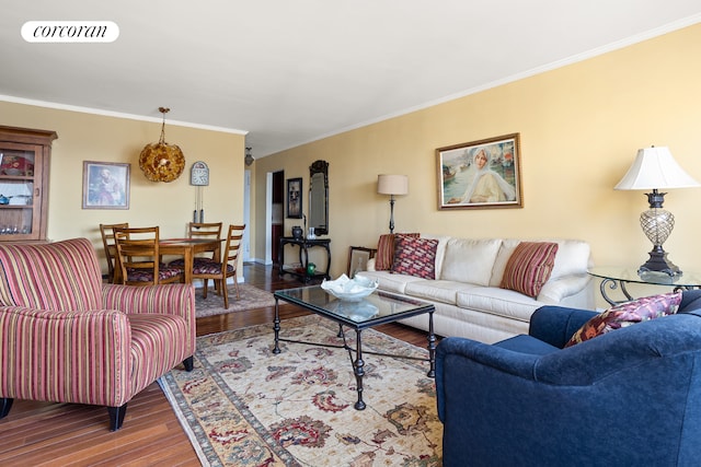 living room featuring wood finished floors and crown molding
