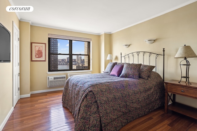 bedroom with hardwood / wood-style flooring, a wall mounted AC, baseboards, and crown molding