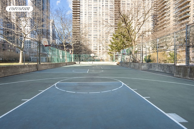 view of basketball court with community basketball court and fence